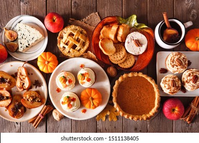 Autumn food concept. Selection of pies, appetizers and desserts. Above view table scene over a rustic wood background.