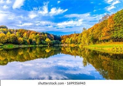 Autumn forest lake in nature landscape - Shutterstock ID 1699356943