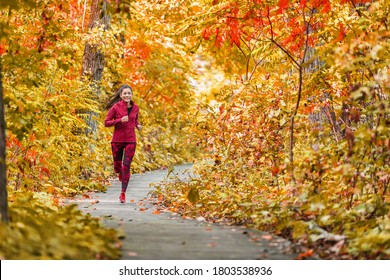 Autumn Forest Run Path. Fall Trail Runner Woman Running In Beautiful Foliage Woods Nature Background. Asian Happy Sports Woman Training Outdoor. 