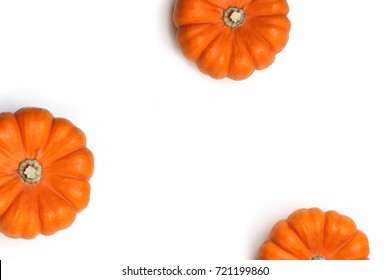 Autumn frame made of orange pumpkins isolated on white background. Fall, Halloween and Thanksgiving concept. Styled stock flat lay photography. Top view. Empty space for your text.