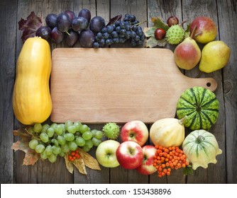 Autumn Fruits And Vegetables And Empty Cutting Board