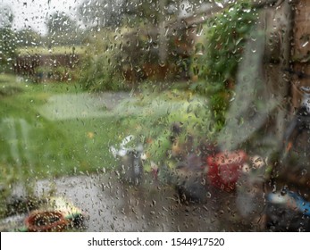 Autumn garden seen through rain splattered window
