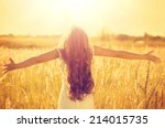 Autumn Girl enjoying nature on the field. Beauty Girl Outdoors raising hands in sunlight rays. Beautiful Teenage Model girl in white dress running on the Field, Sun Light. Glow Sun. Free Happy Woman