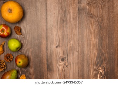 Autumn harvest. Pumpkin, pears, apples, pine cones, and leaves on wooden background. Copy space, top view - Powered by Shutterstock