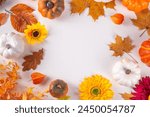 Autumn holidays background. Thanksgiving Day greetings card. Multi-colored pumpkins, autumn leaves and flowers, acorn cones, decor on a white background top view copy space