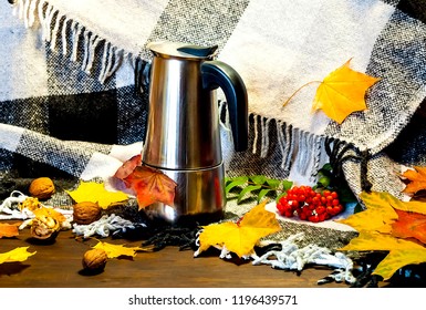 Autumn Home Decor. Metal Coffee Pot Amid Bright Yellow Leaves On Checkered Plaid. Hygge Style, Concept Of Comfort And Coziness.Copy Space, Close Up.