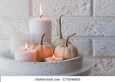 Autumn Home Decor With White Pumpkins And Burning Candles. Cozy Fall Composition