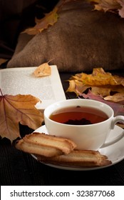 Autumn Hot Tea With Cookies And Falling Leaves Around.