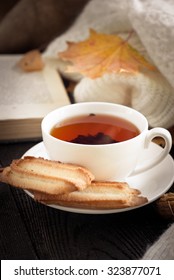 Autumn Hot Tea With Cookies And Falling Leaves Around.