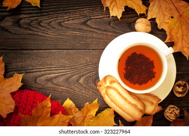 Autumn Hot Tea  And Falling Leaves Around. Top View, Copy Space.