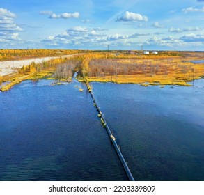 Autumn Industrial Landscape. Western Siberia. Oil Pipeline On Water. Oil Field.