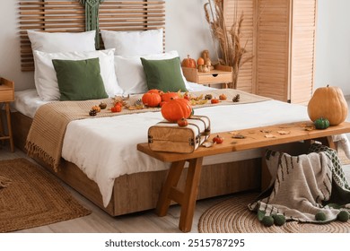 Autumn interior of stylish bedroom with pumpkins and suitcase - Powered by Shutterstock