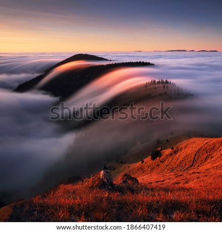 Autumn landscape, beautiful sunrise above the heavy clouds, Mountain sea
