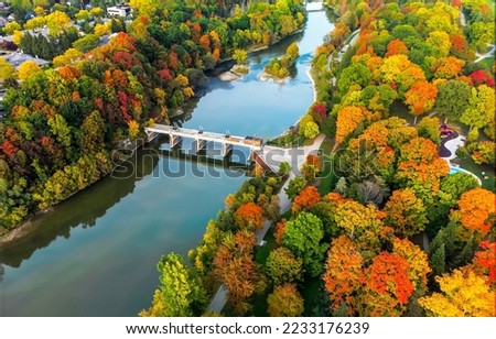 Autumn landscape of the bridge over the river, top view. River bridge in autumn. Beautiful autumn landscape. Colorful autumn scene
