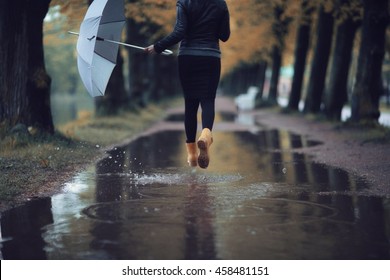 Autumn Landscape City Woman Umbrella Rain Puddles Of Yellow Trees