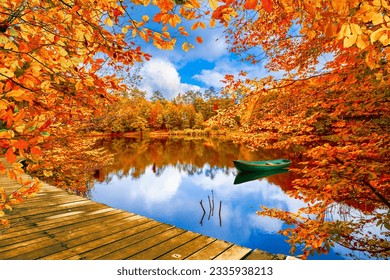 Autumn landscape in colorful lake. Golden fall leaves on beautiful lake. Red forest scenery in stunning nature. Autumn colors in the pond in the deep forest. Fall season in colorful forest. - Powered by Shutterstock