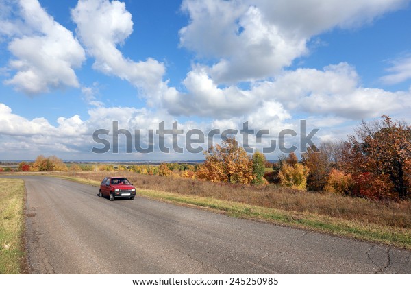 autumn landscape desert\
road to the horizon in the field and beautiful white clouds in\
sunny afternoon