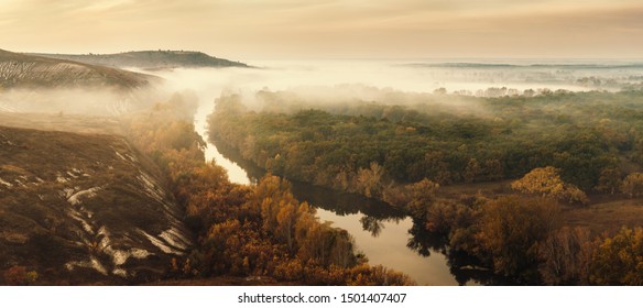Autumn landscape with fog in valley above river, foggy morning. Retro stylization, vintage film filter