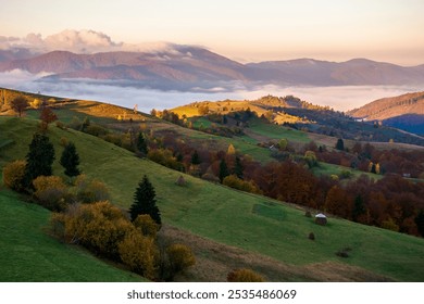 autumn landscape of mountainous countryside. rustic farmland. sunny morning. rural fields and rolling hills. fog in the distant valley. picturesque vacation - Powered by Shutterstock