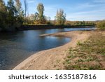 Autumn landscape river sandy shores, rifts and stretches, dark blue cold water, a sad time to catch eyes, a colorful farewell to the summer