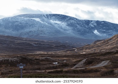 Autumn landscape with secluded houses in the mountains against the backdrop of majestic snow-capped peaks - Powered by Shutterstock