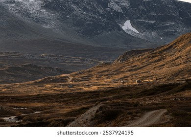 Autumn landscape with secluded houses in the mountains against the backdrop of majestic snow-capped peaks - Powered by Shutterstock