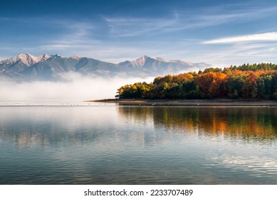 Autumn landscape. Water reservoir Liptovska Mara and Western Tatras mountains at background.