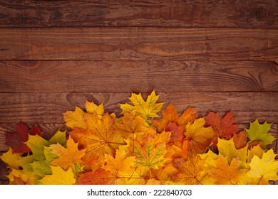 Autumn Leaves On A Wooden Table.