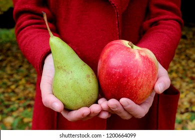 Autumn leaves zholtye hands red apple and green pear coats woman