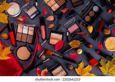 Autumn Make Up Set On Black Table Background, With Autumn Leaves And Beauty Accessories. Various Makeup Professional Cosmetics On White Table Background With Fall Cozy Sweater And Woman Handbag