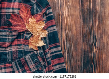 Autumn Maple Leaves On Mens Plaid Shirt. Autumn Fashion Style. Fall Season Concept. Top View, Copy Space