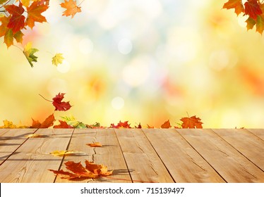 Autumn maple leaves on wooden  table.Falling leaves natural background. - Shutterstock ID 715139497