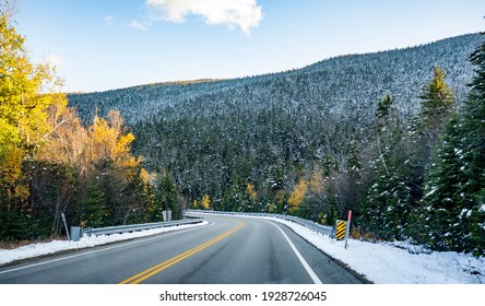 Autumn Maples And Winter Snow-covered Winding Road With First Snow Dusted Trees On The Mountains In Vermont Invite Tourists And Travelers To Visit The Meeting Point Of The Two Seasons In New England