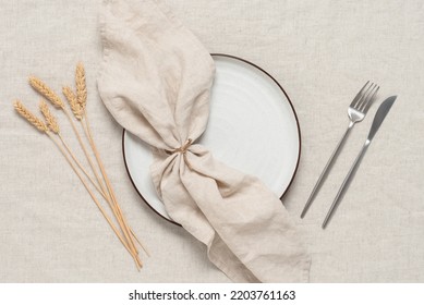 Autumn Minimal Table Setting With Ripe Ears Of Wheat On A Beige Linen Textile Background. View From Above.