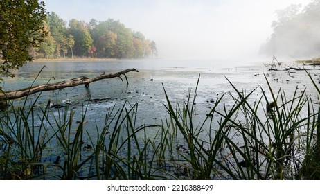 Autumn Morning Fog Lifting Over A Mountain Lake.