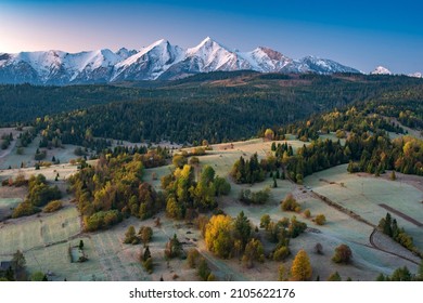 Autumn Morning With High Tatras View. Frosty Autumn Meadows With Colorful Trees And Snowy Mountains. Vysoke Tatry, Slovensko, Slovakia