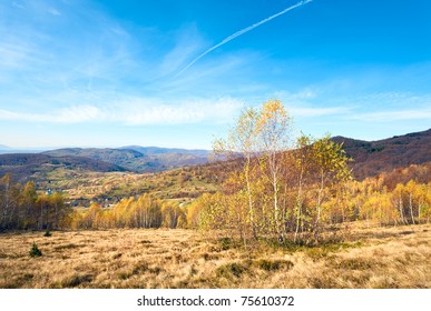 Autumn Mountain Country Landscape With Village ,birch Trees And Vapour Trail In Sky(Carpathian, Ukraine).