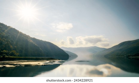 autumn mountain landscape with green forest and lake against the background of the rays of the sun and sky and clouds in Georgia - Powered by Shutterstock