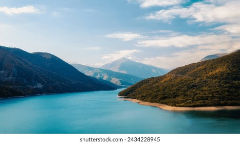 autumn mountain landscape with green forest and lake and sky and clouds in Georgia - Powered by Shutterstock