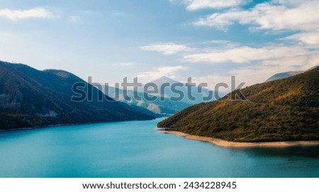 autumn mountain landscape with green forest and lake and sky and clouds in Georgia