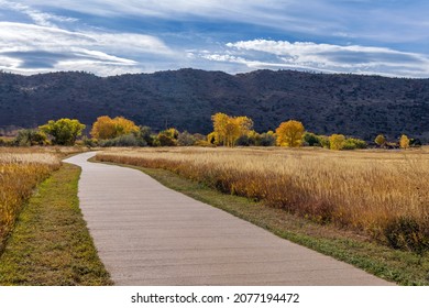 Autumn Mountain Park - A sunny Autumn day view of a winding biking and hiking path at Bear Creek Lake Park, Denver-Lakewood, Colorado, USA.