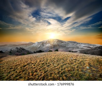 Autumn mountains and dry grass at sunset - Shutterstock ID 176999876