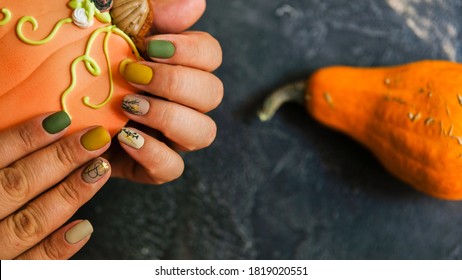 Autumn Nails Design. Trendy Manicure. Top View. Place For Text. Autumn Leaves And Pumpkins