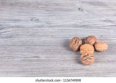 autumn nuts laid on anthracite gray wood in background