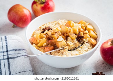 Autumn Oatmeal With Caramelized Apple And Cinnamon In White Bowl. Winter Cozy Recipe. Healthy Comfort Food.