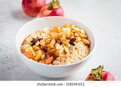 Autumn Oatmeal With Caramelized Apple And Cinnamon In White Bowl. Winter Cozy Recipe. Healthy Comfort Food.