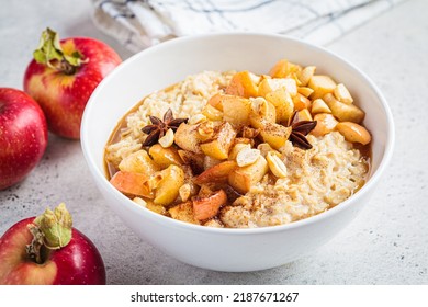 Autumn Oatmeal With Caramelized Apple And Cinnamon In White Bowl. Winter Cozy Recipe. Healthy Comfort Food.