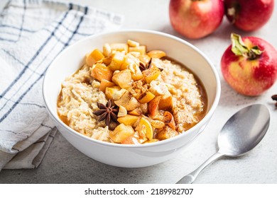 Autumn Oatmeal With Caramelized Apple And Cinnamon In White Bowl. Winter Cozy Recipe. Healthy Comfort Food.