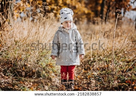 Similar – Image, Stock Photo Cute baby seeing falling leaves