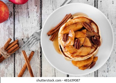 Autumn Pancake Stack With Baked Apples, Pecans And Cinnamon Topped With Maple Syrup, Overhead View